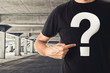 © Bits and Splits - Man in black t-shirt with question mark