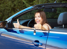 Smiling Caucasian Woman Showing Key In A Cabriolet