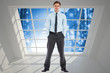 © WavebreakMediaMicro - Composite image of serious businessman standing with hands in po