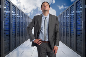 Poster - Composite image of serious businessman with hand on hip