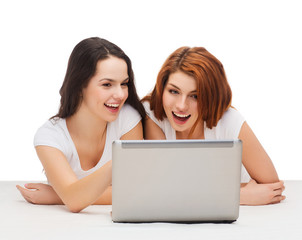 Wall Mural - two smiling teenage girsl with laptop computer