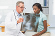 © WavebreakmediaMicro - Doctor showing young patient her chest xray