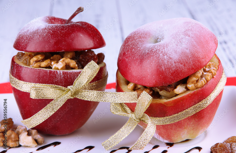 Stuffed apples with nuts and raisins on table close up