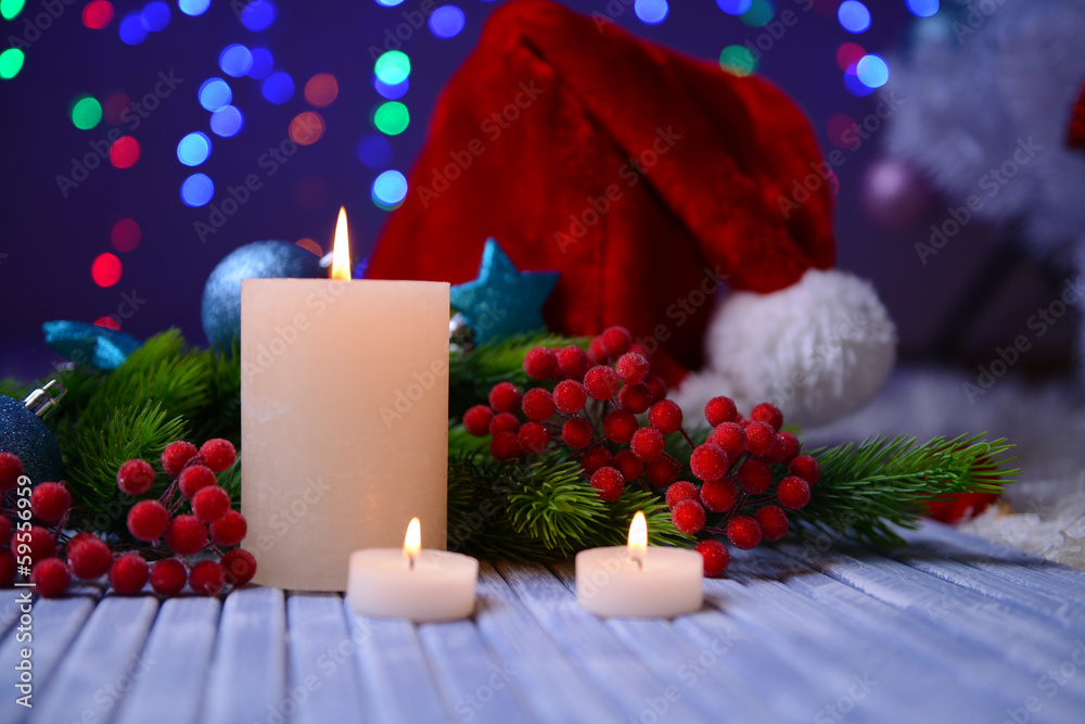 Candles and Christmas decoration on bright background