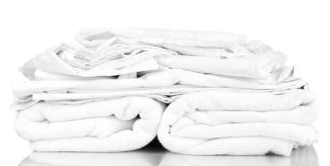 Wall Mural - Stack of rumpled bedding sheets isolated on white