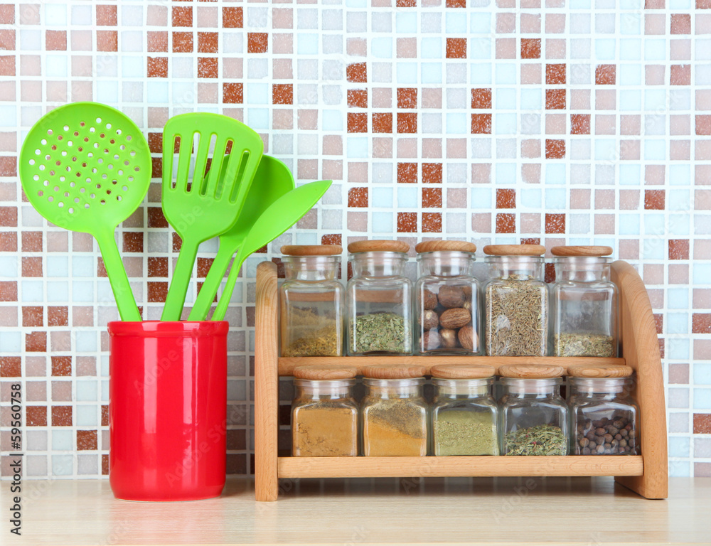 Set of spices, tableware and kitchen utensils in kitchen