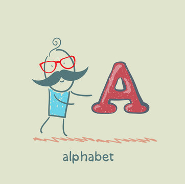 man standing with a letter of the alphabet