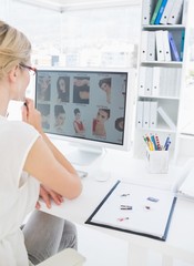 Wall Mural - Rear view of a female photo editor working on computer