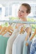 © WavebreakmediaMicro - Happy female customer selecting clothes in store