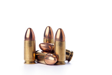 A group of 9mm bullets for a a gun isolated on white