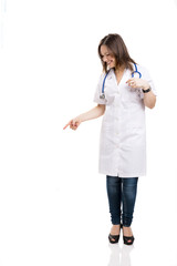 beautiful young veterinary looking down and pointing, isolated o