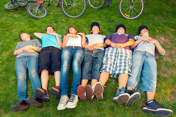 Wall Mural - Resting teenagers  after bicycle ride