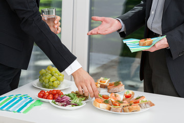 Canvas Print - Business people having meal together