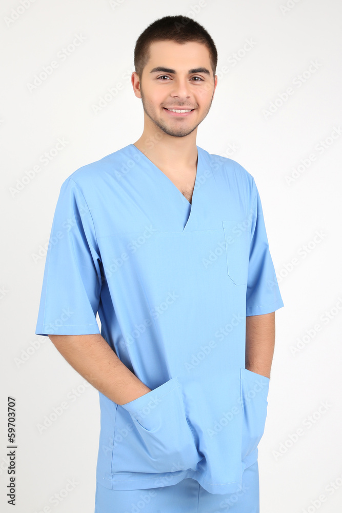Young male doctor isolated on white
