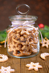 Wall Mural - Delicious Christmas cookies in jar on table on brown background