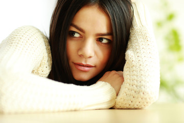 Canvas Print - Closeup portrait of a young pensive woman looking aside