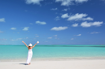 Wall Mural - Girl in the hat on the beach of Exuma, Bahamas