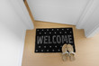 Welcome home on black mat