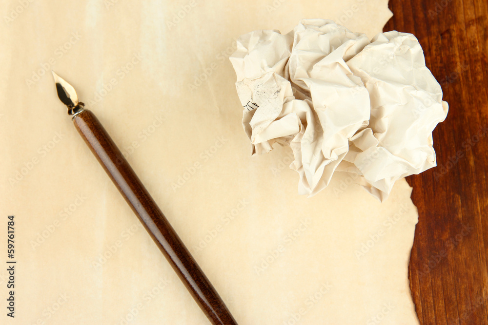 Crumpled paper ball with ink pen on table close up