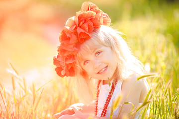 Wall Mural - Cute child girl in poppy field