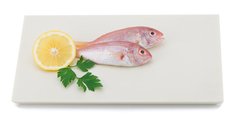 Wall Mural - Fresh pagrus with slice of lemon and parsley on plate