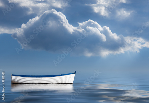 Cuadros en Lienzo Old rowing boat marooned at sea