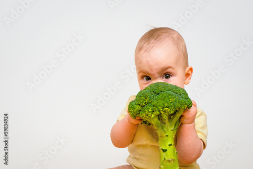 Fototapeta Baby eating broccoli