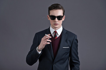 Wall Mural - Retro fifties fashion young businessman with black sunglasses we