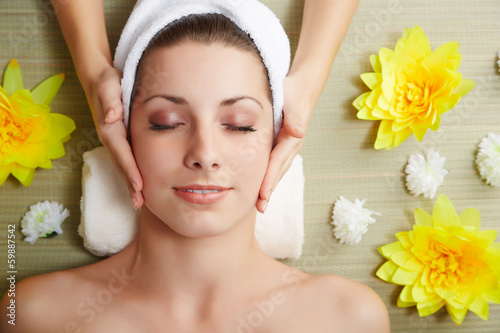 Fotografie, Obraz Beautiful young woman lying relaxed in a spa salon
