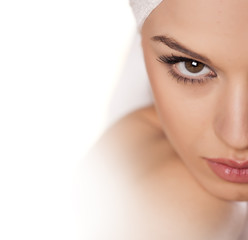 Wall Mural - calm beautiful girl with a towel on her head posing on white