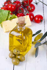 Wall Mural - olive oil in glass bottle in foreground