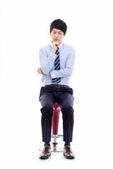 Canvas Print - Young Asian business man sitting on the chair