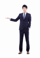 Wall Mural - Young Asian business man showing something