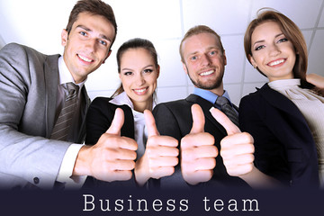 Wall Mural - Business team showing thumbs up in office