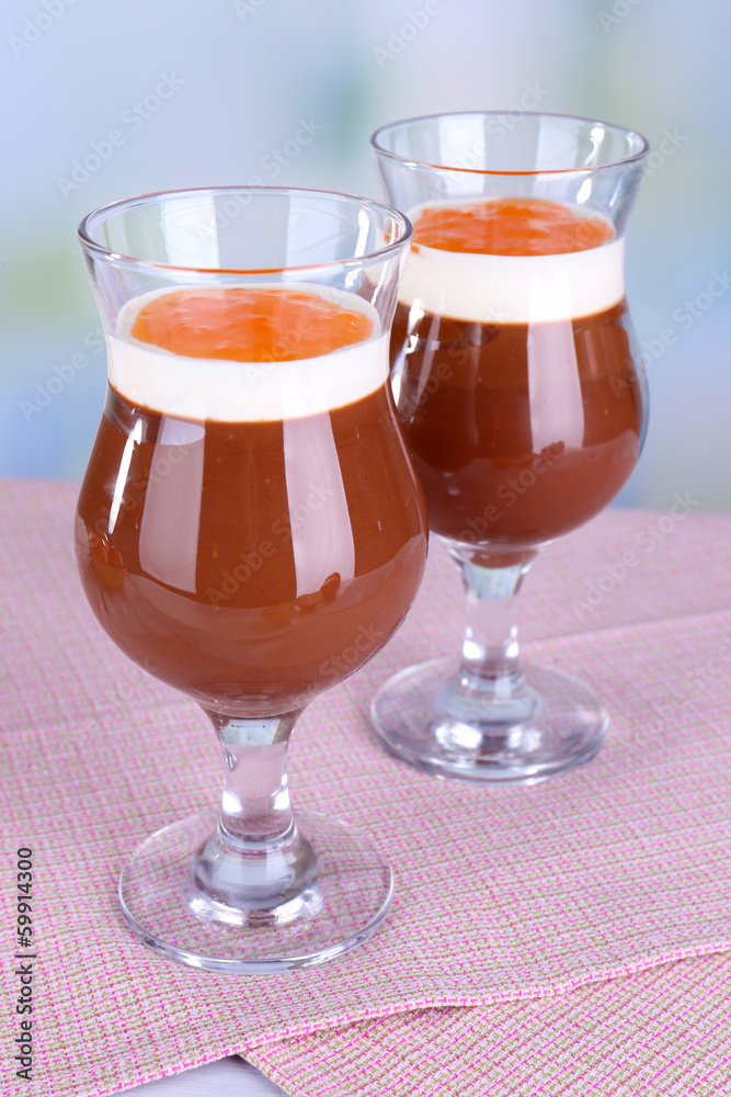Dessert of chocolate and persimmon on table on light background