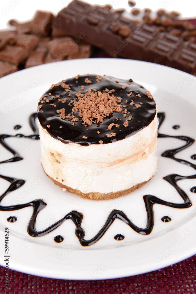 Sweet cake with chocolate on plate on table close-up