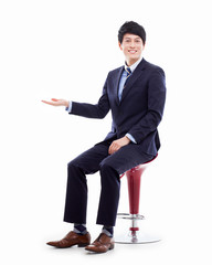 Wall Mural - Young Asian business man showing something