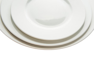 Three empty plates of different sizes over white background