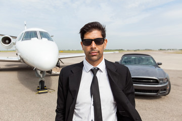 Wall Mural - Entrepreneur In Front Of Car And Private Jet