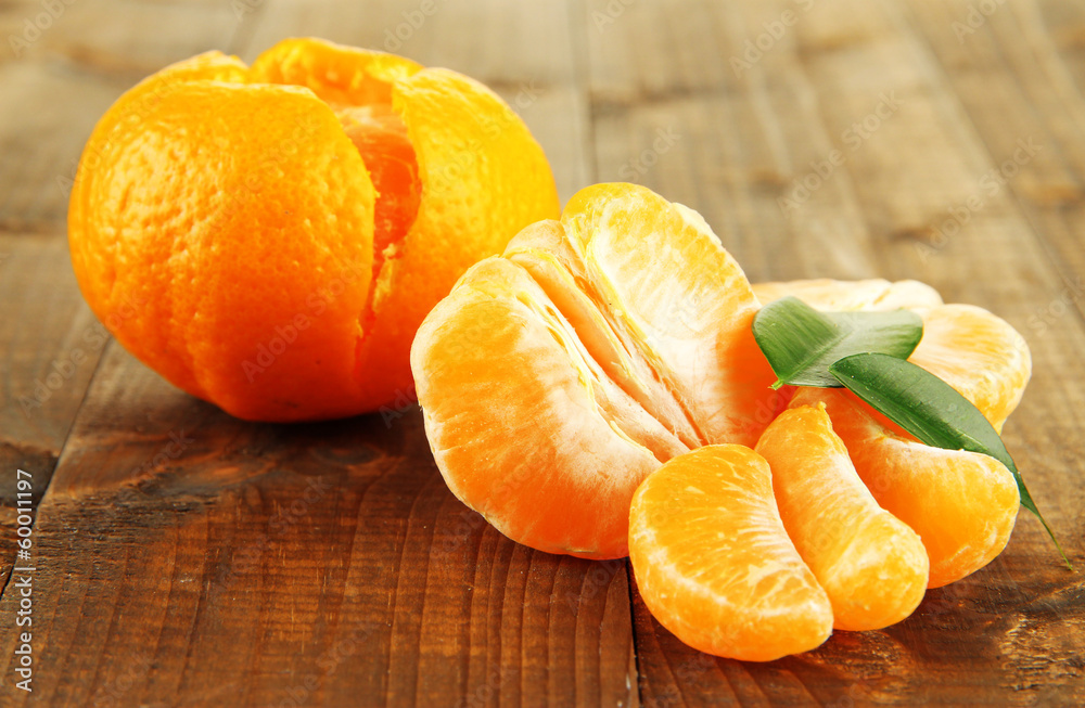 Ripe tangerines on wooden background
