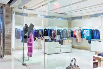 Poster - Boutique display window with mannequins in fashionable dresses