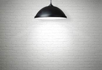 white brick wall illuminated by the lamp with copy space