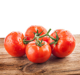 Wall Mural - Tomatoes on a wooden background