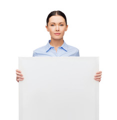 Canvas Print - serious businesswoman with white blank board