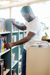 © Tyler Olson - Librarian Arranging Books In Library