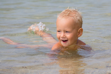 Happy baby at the sea