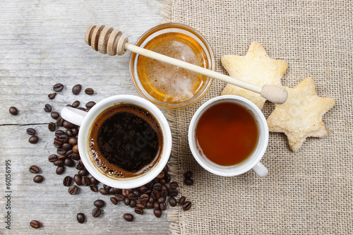 Naklejka na meble Cup of coffee, cup of tea and bowl of honey on wooden table.