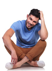 Wall Mural - seated casual man passing his hand through his hair