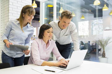 Business team working on laptop in office