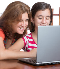 Hispanic teenager and her mother browsing the web